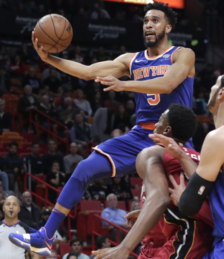 Courtney Lee of the New York Knicks drives past Hassan Whiteside of the Miami Heat during the first half of Miami's 107-103 overtime victory.