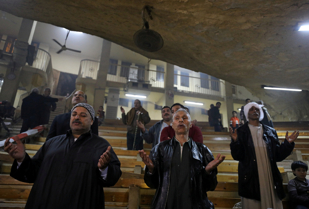 Coptic Orthodox Christians attend Christmas Eve Mass at a church in Saint Samaan the Tanner Monastery in Cairo, Egypt, on Saturday.