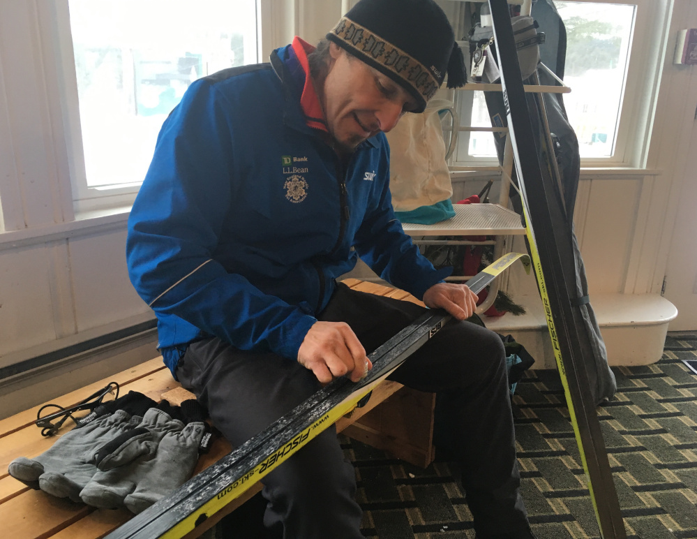 Norm Greenberg of Hanover puts wax on his skis Saturday before going out on the Bethel Village Trails in Bethel.