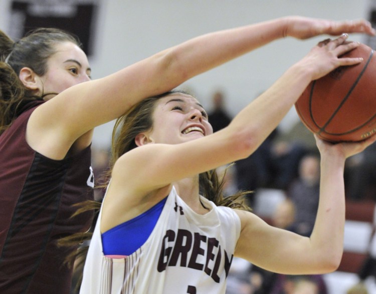 Mackenzie Holmes of Gorham tries to block a shot by Greely's Camille Clement but gets called for a foul. Holmes spent much of the game in foul troubled but still scored 21 points, while Clement finished with 13 points.