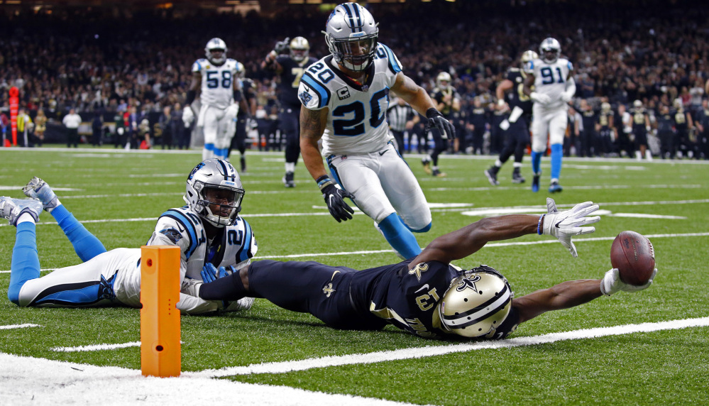 Saints receiver Michael Thomas reaches over the goal line after being tackled short of the end zone by Carolina's James Bradberry during the Saints' 31-26 playoff win Sunday.