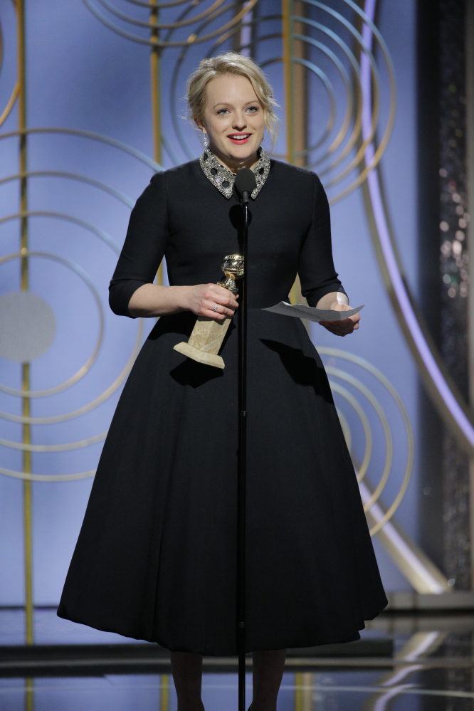 Elisabeth Moss accepts the award for best actress in a drama series for her role in "The Handmaid's Tale" at the Golden Globe Awards in Beverly Hills, Calif., on Sunday.