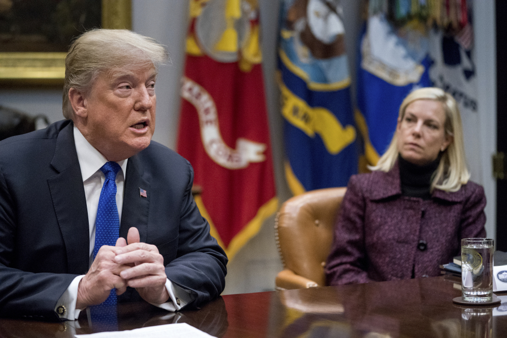 President Trump, accompanied by Secretary of Homeland Security Kirstjen Nielsen, right, meets with Republican senators on immigration in the Roosevelt Room at the White House in Washington. The Trump administration is ending protections for Salvadoran immigrants.