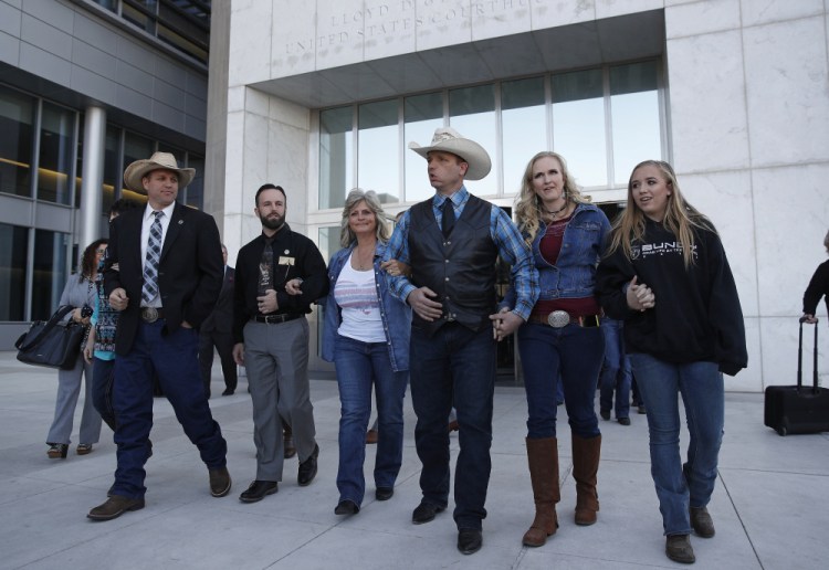 From left, Ammon Bundy, Ryan Payne, Jeanette Finicum, widow of Robert "LaVoy" Finicum, Ryan Bundy, Angela Bundy, wife of Ryan Bundy, and Jamie Bundy, daughter of Ryan Bundy, walk out of a federal courthouse in Las Vegas.
