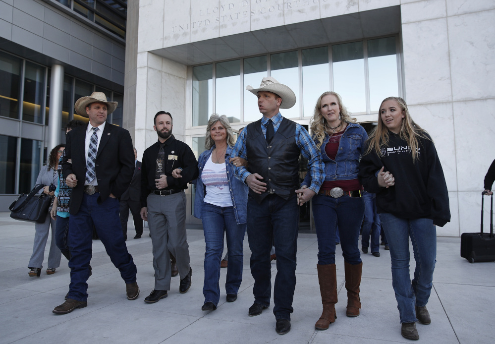 From left, Ammon Bundy, Ryan Payne, Jeanette Finicum, widow of Robert "LaVoy" Finicum, Ryan Bundy, Angela Bundy, wife of Ryan Bundy, and Jamie Bundy, daughter of Ryan Bundy, walk out of a federal courthouse in Las Vegas.