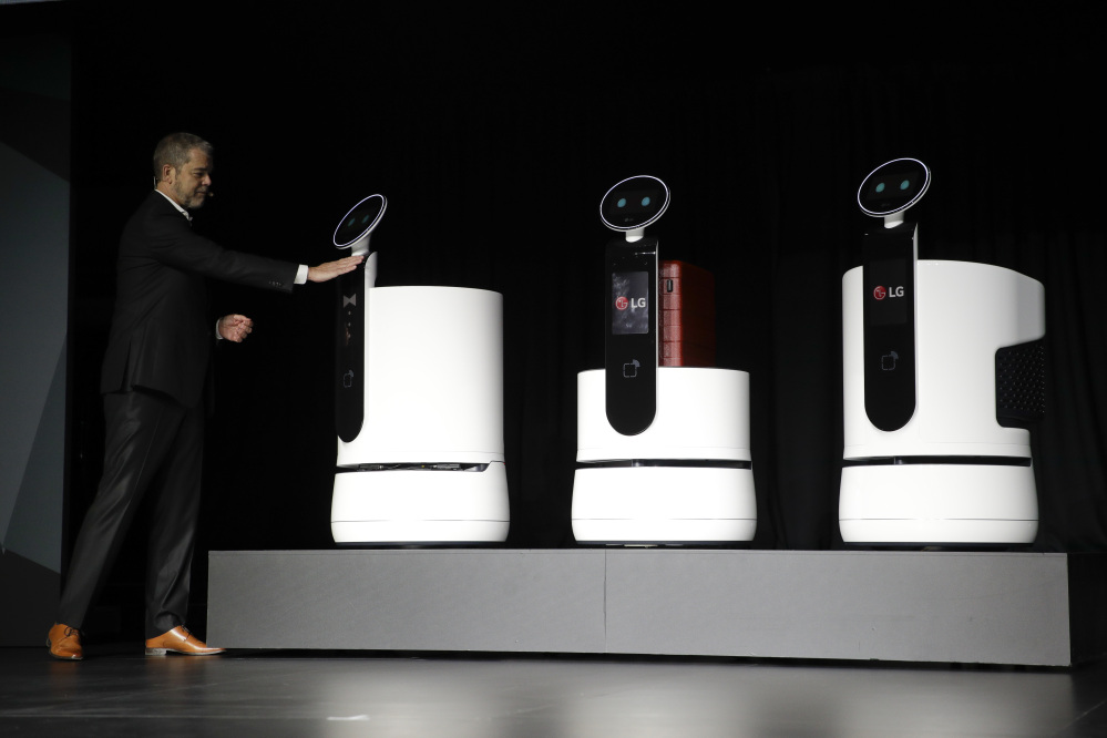 LG's David Vander Waal introduces the new-concept robots during a news conference at CES International Monday. (AP Photo/Jae C. Hong)