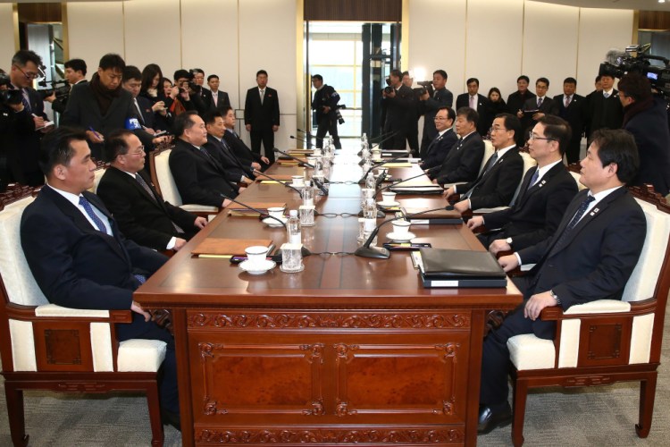 South Korean Unification Minister Cho Myoung-gyon, third from right, and head of North Korean delegation Ri Son Gwon, third from left, and their delegations meet at the Panmunjom in the Demilitarized Zone in Paju, South Korea, on Tuesday. Senior officials said they would try to achieve a breakthrough in their long-strained ties as they sat for rare talks at the border to discuss how to cooperate in next month's Winter Olympics in the South and other issues.
