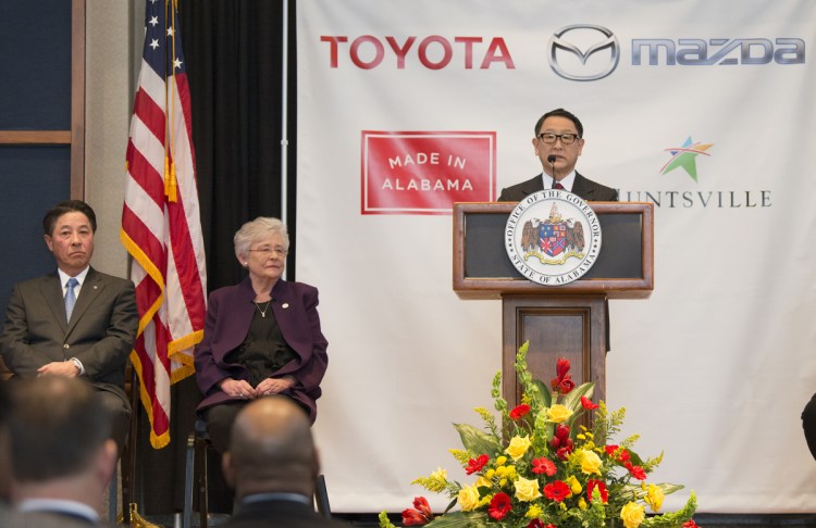 Akio Toyoda, right, of Toyota Motor Corp., speaks as Gov. Kay Ivey, center, and Masamichi Kogai, Mazda Motor Corp. president and CEO, listen during a news conference Wednesday in Montgomery, Ala. The Japanese automakers announced plans to build a $1.6 billion joint-venture plant in Huntsville.