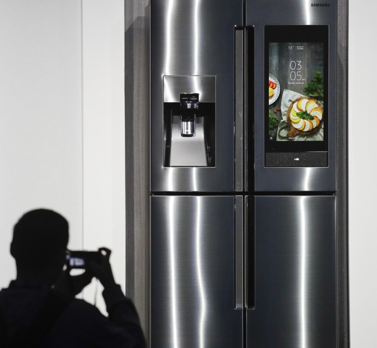 The 2018 model of the Samsung Family Hub smart refrigerator, which syncs up food storage with meal preparation and expands voice control by the personal assistant Bixby, is displayed at the CES gadget show in Las Vegas.