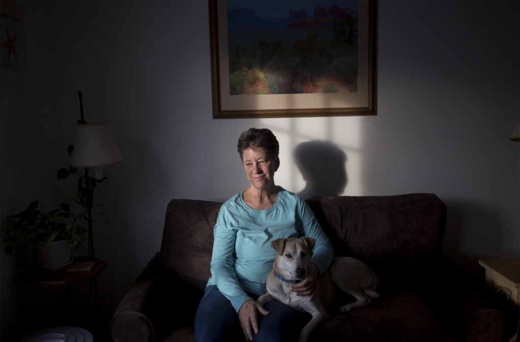 It's unclear, under the policy change whether Judy Bullard, holding her dog, Skylar, might be required to work or volunteer to get Medicaid that helps pay to treat her epilepsy.