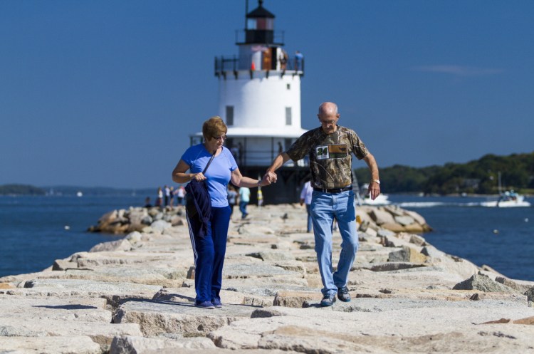 Visitors like Marie and Douglas Pyle of Lewisville, Texas, seen in South Portland during Open Lighthouse Day in 2015, bring $6 billion a year to Maine. Tourism and lobstering, a $1.7 billion-a-year industry, have an economic impact far greater than the fossil fuel industry ever could here.