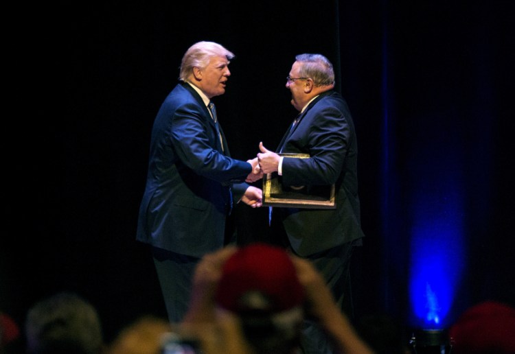 Donald Trump greets Gov. Paul LePage during a 2016 campaign stop in Portland. Imagine a country with leaders who act to benefit industry without regard to consequences, a reader suggests.