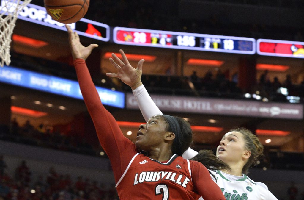 Louisville's Myisha Hines-Allen goes for a layup past Notre Dame's Kathryn Westbeld in the first half Thursday night in Louisville, Ky. Louisville crushed Notre Dame, 100-67.