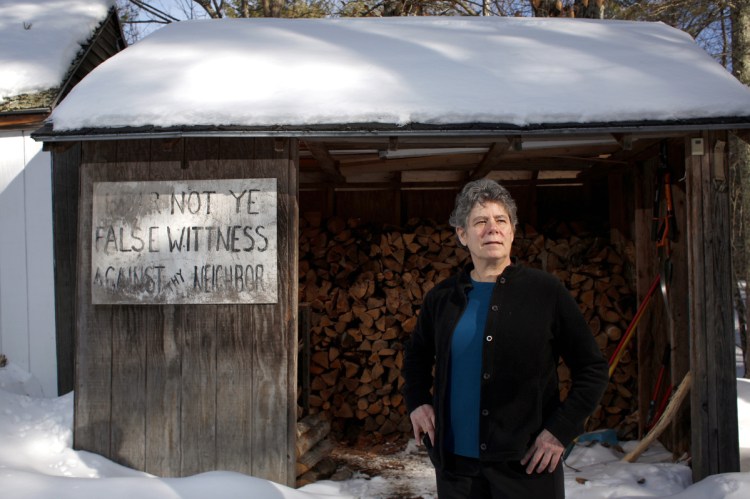 Anne Gass, shown outside her woodshed in Gray, says, "I'm very excited to see so many women are willing to step up at this point and say no more." The sign on Gass' shed was a prop in a play.