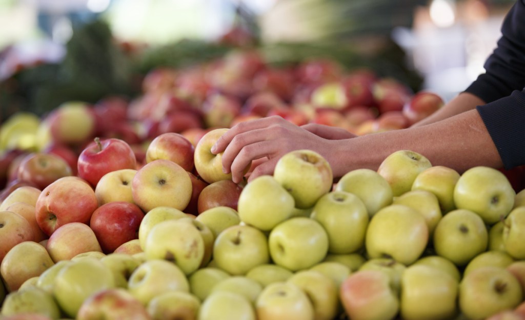 Apples are shown at a farmers market. A pesticide used on citrus fruits and other crops would be restricted under an EPA proposal.