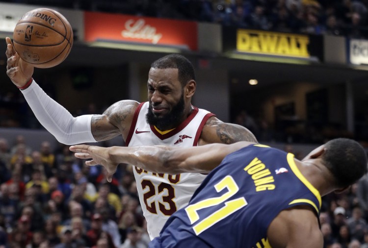 LeBron James of the Cleveland Cavaliers is fouled by Thaddeus Young of the Indiana Pacers while going up to shoot Friday night during the first half of Indiana's 97-95 victory. The Cavaliers have lost three straight games.