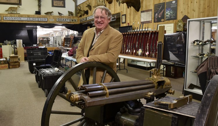 Jim Julia with an 1870s Gatling gun that will be auctioned at his Fairfield business, James D. Julia Auctioneers Inc. Julia has sold the internationally known company, which he says has "handled some of the greatest gun collections sold in this country in the last 20 years."