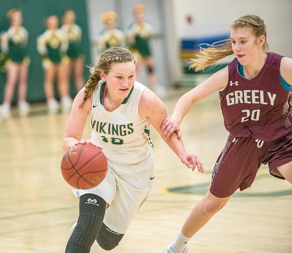 Ceceila Dieterich drives against Greely's Anna DeWolfe during their girls' basketball game Saturday in South Paris. Greely rallied for a 46-39 win.