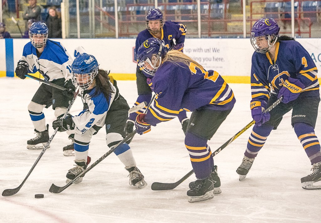 Lewiston's Madison Conley maneuvers around Abby Enck of Cheverus/Kennebunk during Saturday night's game at the Androscoggin Bank Colisee. Cheverus/Kennebunk won in overtime, 4-3.