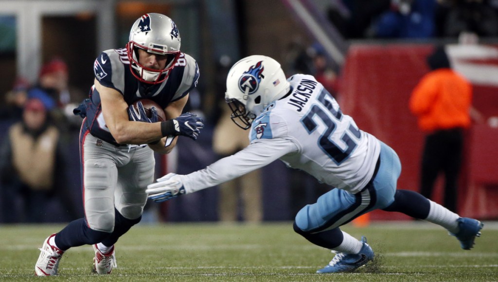 Danny Amendola tries to get away from Titans cornerback Adoree Jackson after catching a pass Saturday night at Gillette Stadium. Amendola set career playoff highs with 11 receptions from 112 yards.