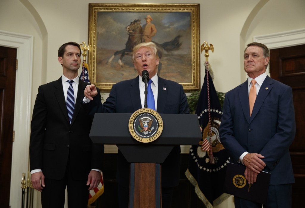 Sens. Tom Cotton, R-Ark., left, and David Perdue, R-Ga., right – who previously said they could not recall whether President Trump, center, had referred to "sh--hole countries" at a meeting they all attended – denied outright on TV news programs Sunday that Trump had ever said it.