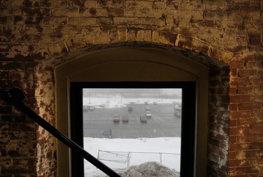 BIDDEFORD, ME - JANUARY 12: The site of the former Maine Energy Recovery Company, seen here through the window of a neighboring building in a photo taken on Friday, January 12, 2018, is one of three sites for a 400-car parking garage being considered by the Biddeford City Council. Officials say the parking garage is necessary for further economic development. (Staff Photo by Gregory Rec/Staff Photographer)