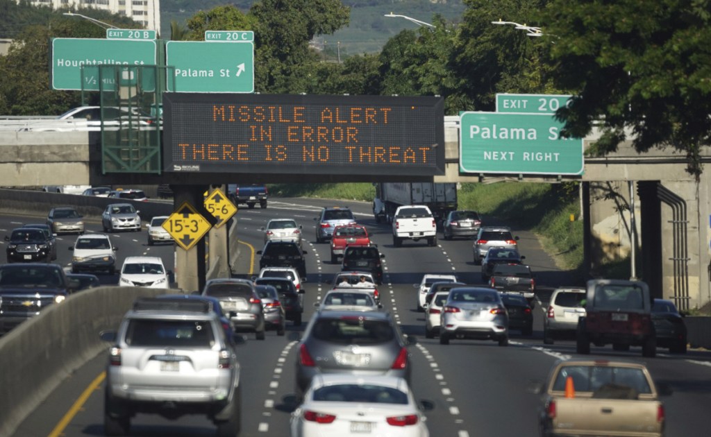 In this Saturday, Jan. 13, 2018 photo provided by Civil Beat, cars drive past a highway sign that says "MISSILE ALERT ERROR THERE IS NO THREAT" on the H-1 Freeway in Honolulu. The state emergency officials announced human error as cause for a statewide announcement of an incoming missile strike alert that was sent to mobile phones.