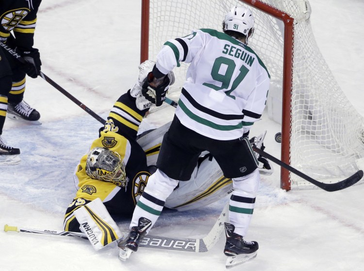 Bruins goaltender Anton Khudobin falls to the ice as Stars center Tyler Seguin scores the winning goal during overtime in Monday's game at Boston.