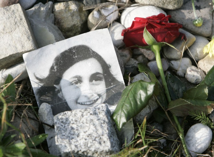 A photo of Anne Frank, who famously chronicled the two years when her family was hidden from the Nazis, is seen at a memorial at the concentration camp where she died.