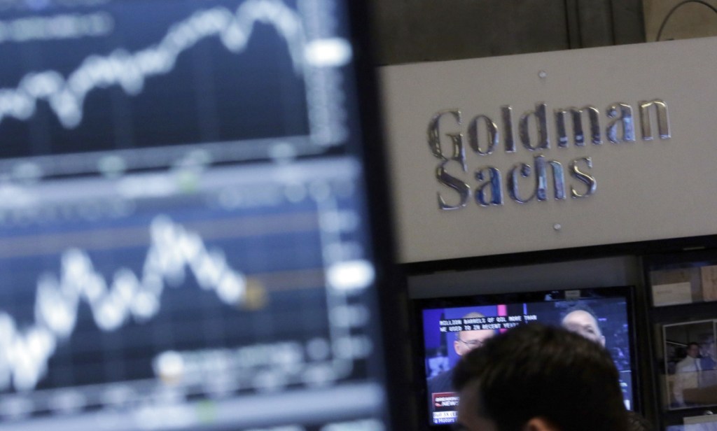 Goldman Sachs lost $5.51 a share in the fourth quarter, compared with a profit of $2.35 billion, or $5.08 a share, in the same period a year earlier, the bank reports.