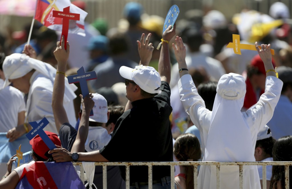Nuns and a priest celebrate during a meeting of Pope Francis with young people Wednesday at the Shrine of Maipu in Santiago, Chile.