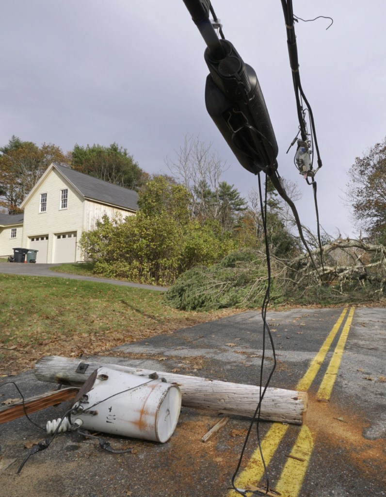 A pole with a transformer attached lies on Flying Point Road in Freeport on Nov. 3, 2017, days after a severe windstorm knocked out electricity to hundreds of thousands of customers across the state. 