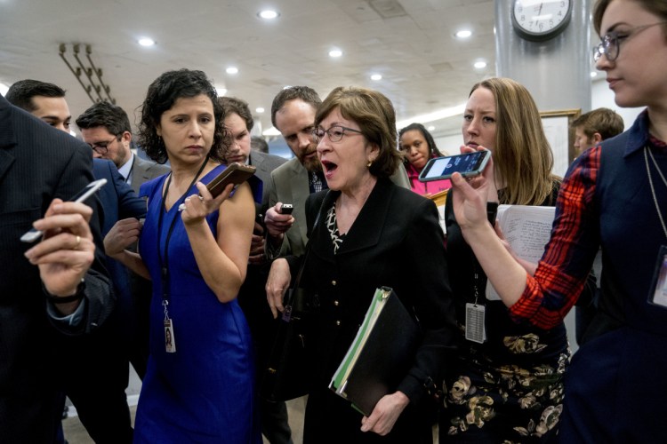 U.S. Sen. Susan Collins, R-Maine, speaks to reporters Thursday while walking toward the Senate chamber as Congress moves closer to its deadline to avoid a government shutdown.