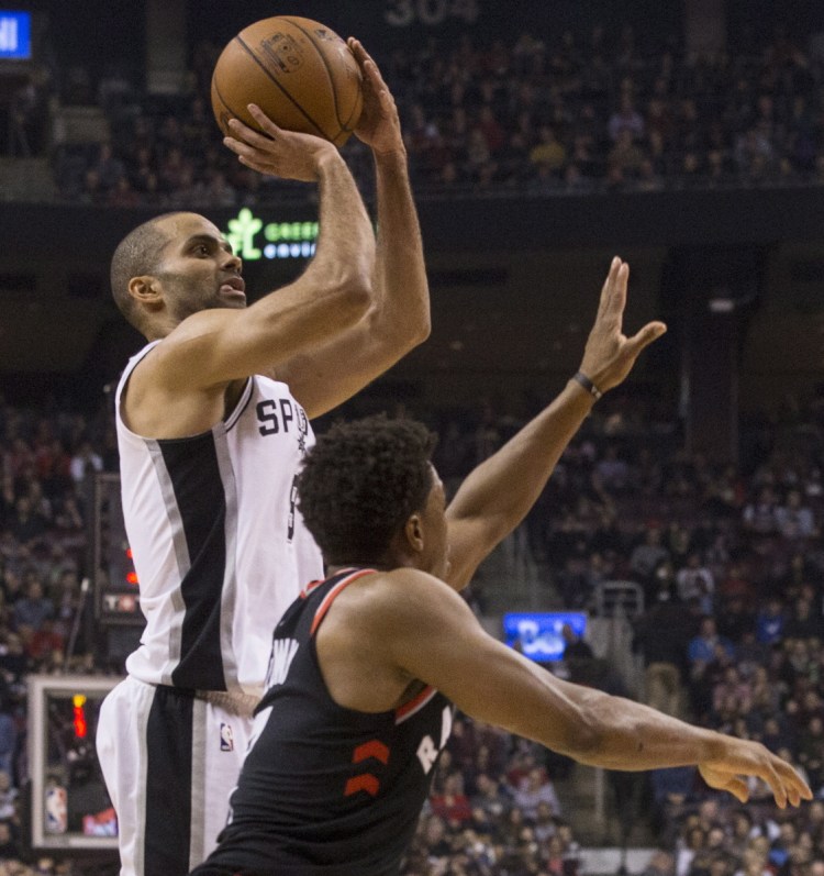 San Antonio guard Tony Parker shoots over Raptors guard Kyle Lowry during the first half of Toronto's 86-83 victory at home Friday night.