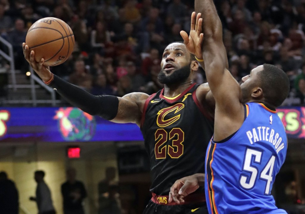 Cleveland's LeBron James drives to the basket while being defended by Oklahoma City's Patrick Patterson during the Thunder's 148-124 win Saturday in Cleveland. James scored 18 points and is seven shy of 30,000 for his career.