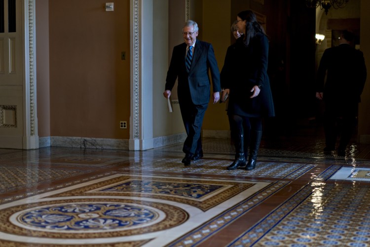 Bloomberg/Andrew Harrer
Senate Majority Leader Mitch McConnell, R-Ky., left, walks toward the Senate Chamber at the Capitol on Sunday.