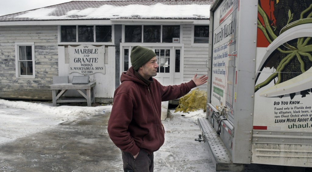 Nate Taczli said file cabinets and ephemera from the firm he manages, S. Masciadri & Sons, is loaded on a rental truck at the Hallowell headstone carver's shop on the banks of the Kennebec River in Hallowell. Forecasts call for rain and warmer temperatures on Tuesday, increasing the risks of flooding. The monument business has been located at the same spot since 1918.