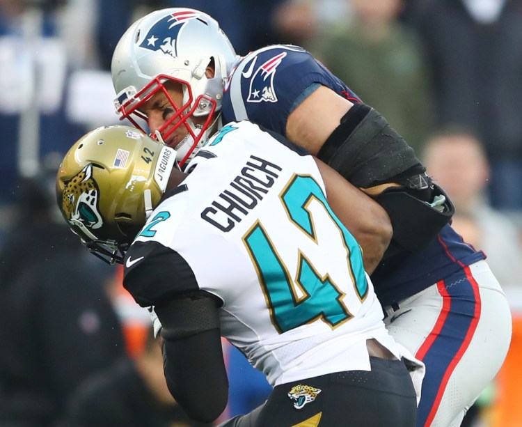 Jacksonville strong safety Barry Church hits Patriots tight end Rob Gronkowski during the AFC championship game Sunday. Gronkowski left the game with a head injury.