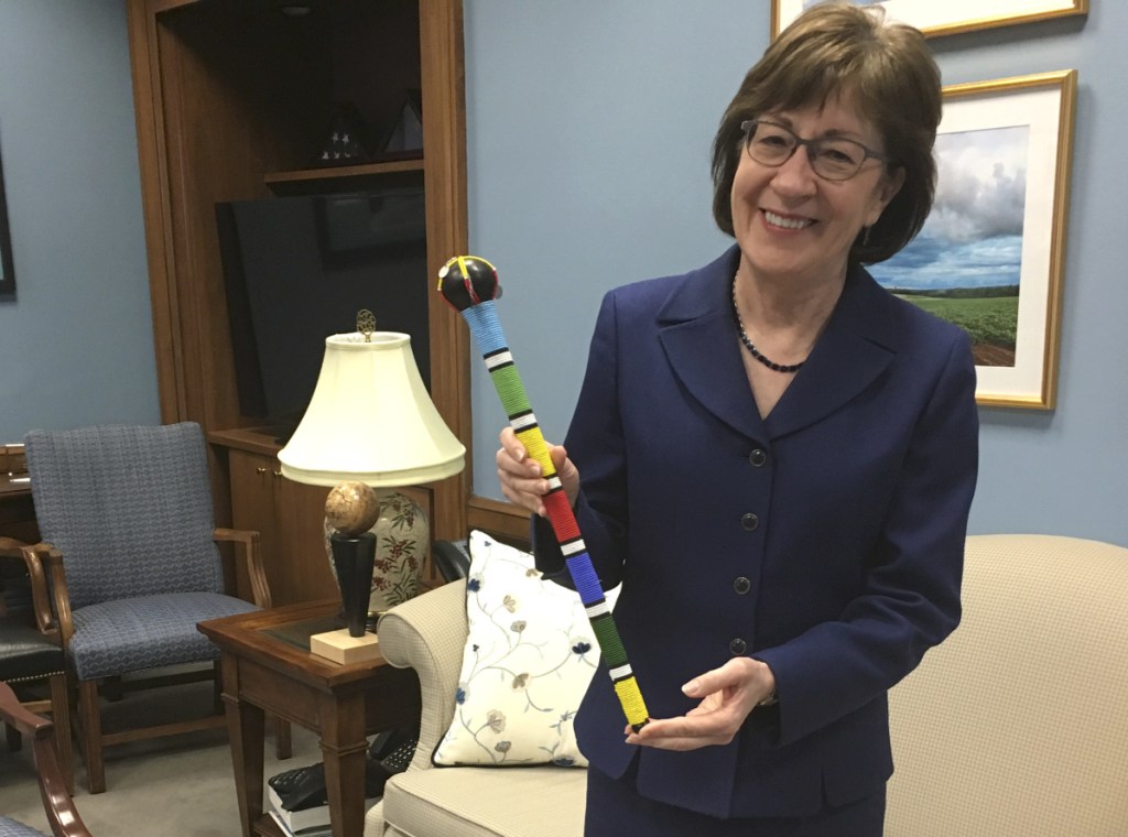 Sen. Susan Collins, R-Maine, holds a colorfully beaded Native American "talking stick" in her office on Capitol Hill in Washington on Monday. Collins employed the stick, given to her by her colleague, Sen. Heidi Heitkamp, D-N.D., to help bring order out of the chaos as senators gathered in her office to work on a compromise.