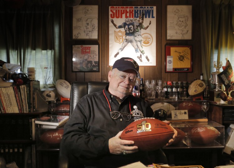 Don Crisman holds a Super Bowl 50 football at his home in Kennebunk in a January 2017 file photo.