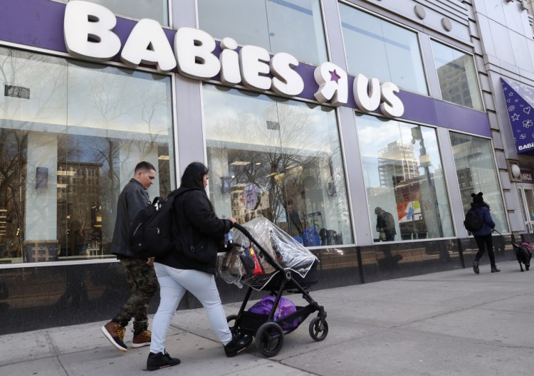 Queens residents Carlos Lopes, left, and Katiria Maldonado and their young child leave Babies R Us after shopping at Manhattan's Union Square store in New York, Wednesday, Jan. 24, 2018. The couple said they were "shocked" to hear about the store's closing. Toys R Us, which owns Babies R Us, has been squeezed by Amazon.com and huge chains like Walmart. The company will close 180 stores, or about 20 percent of its U.S. locations, within months. Some Toys R Us locations will be combined with Babies R Us. (AP Photo/Kathy Willens)