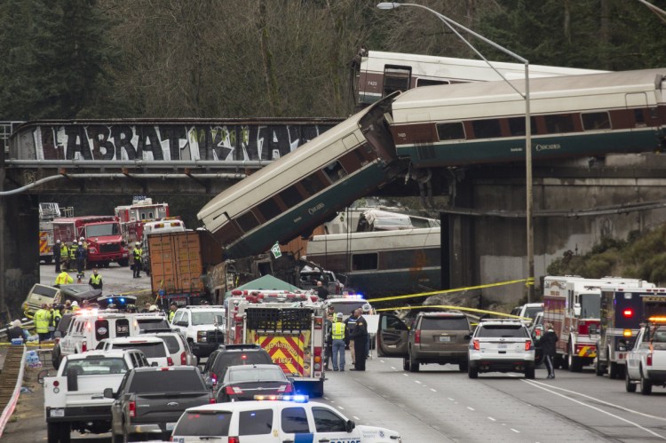 Amtrak train cars lie on Interstate 5 after a derailment in DuPont, Washington in Dec. 2017.