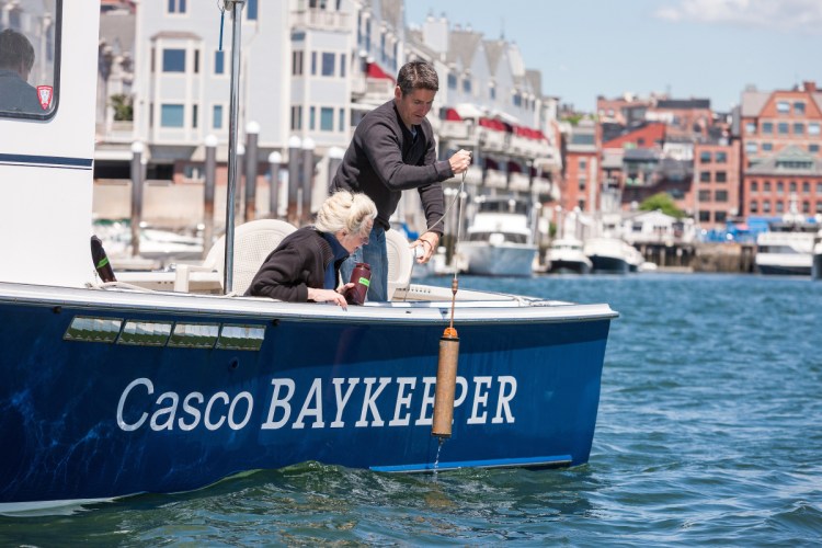 Friends of Casco Bay Executive Director Cathy Ramsdell and Mike Doan, research associate, collect water samples in Portland Harbor.