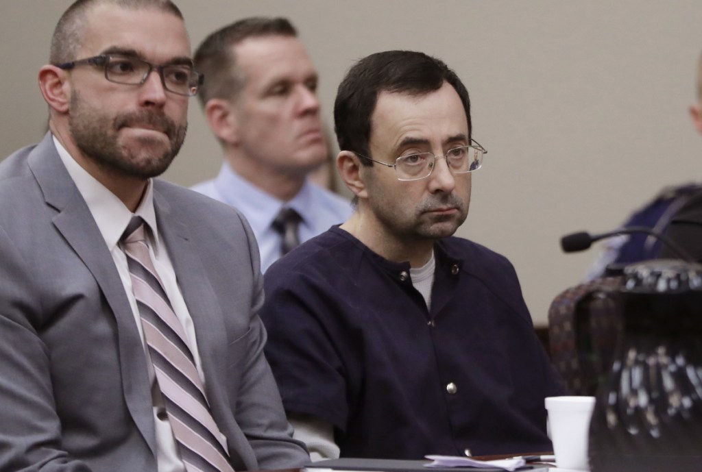 Larry Nassar sits with attorney Matt Newburg during his sentencing hearing Wednesday in Lansing, Mich. The former sports doctor who admitted molesting some of the nation's top gymnasts for years was sentenced to 40 to 175 years in prison.
