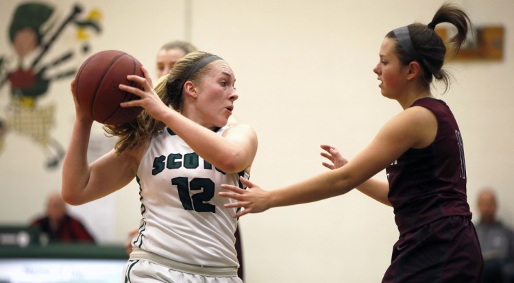 Deirdre Sanborn of Bonny Eagle keeps the ball away from Gorham's Brittany Desjardin during their Class AA South basketball game Friday night in Standish. Sanborn scored 12 points, including six in the fourth quarter, to lead the Scots to a 43-32 win.