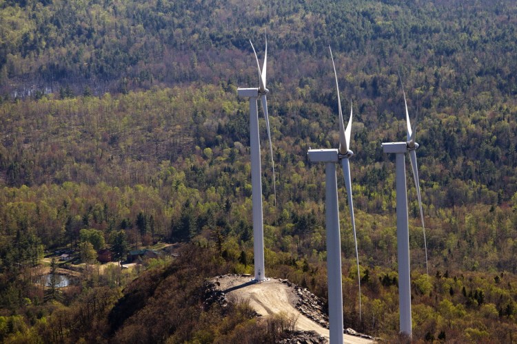 Three wind turbines owned by Patriot Renewables are seen along Saddleback Ridge in western Maine in 2015. Gov. Paul LePage has imposed a moratorium on wind energy permits for western and coastal Maine and created a panel to investigate wind farms' impact on tourism in the state. 