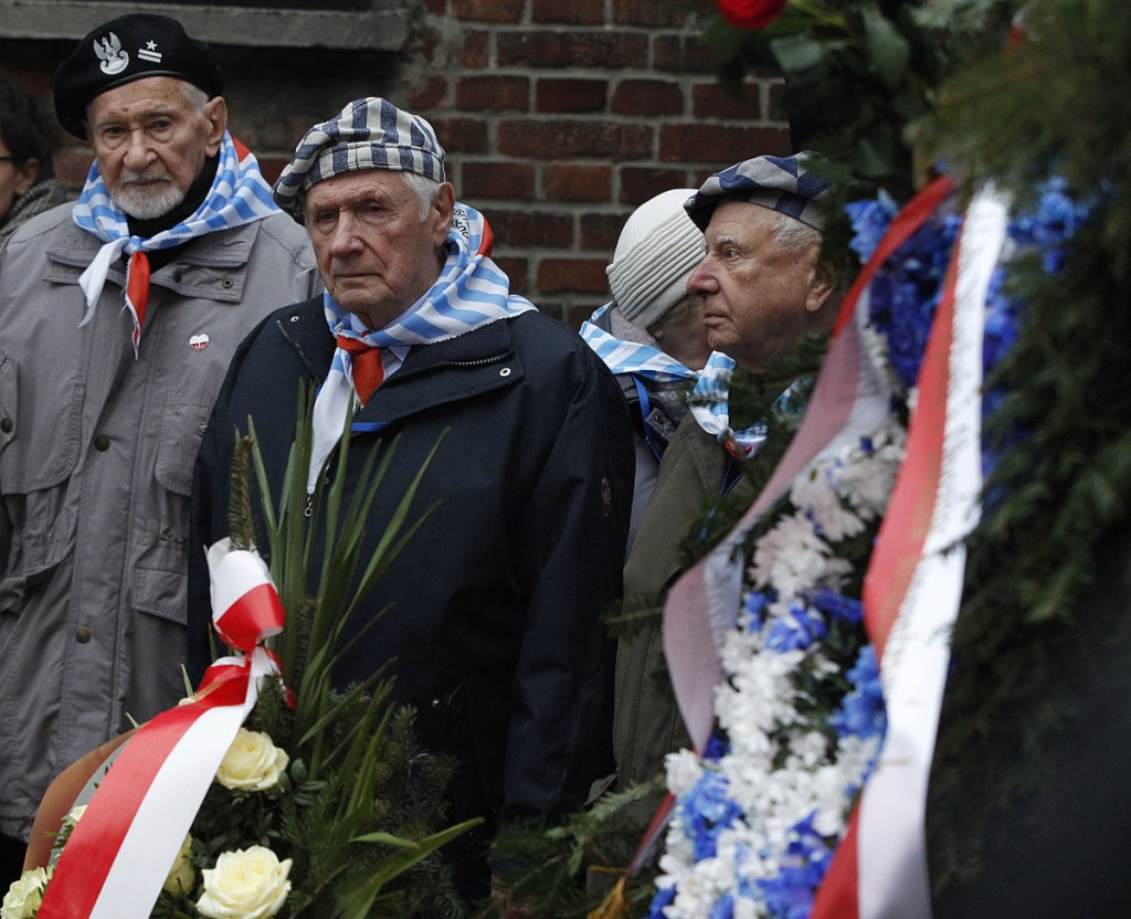 Auschwitz survivors remember those killed by Nazi Germany at the execution wall at the former Auschwitz death camp on International Holocaust Remembrance Day in Oswiecim, Poland, on Saturday. 