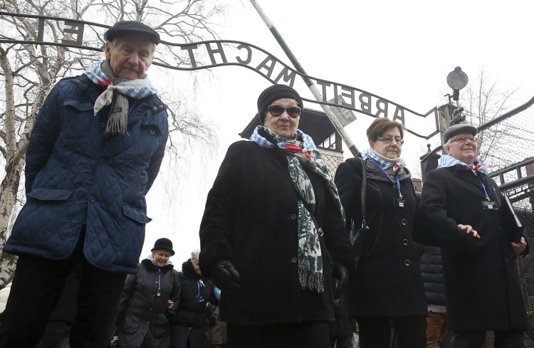 Survivors and guests walk past the "Arbeit Macht Frei" gate at the former Nazi German concentration camp on International Holocaust Remembrance Day in Oswiecim, Poland, on Saturday. It is the 73rd anniversary of the liberation of Auschwitz-Birkenau by the Soviet army.
