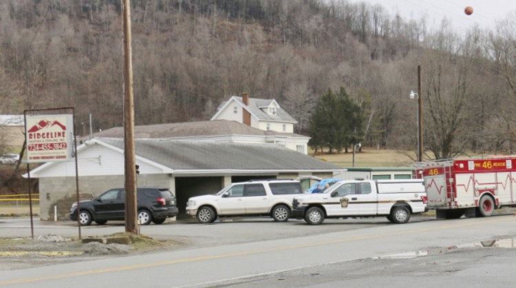 Police officers work the scene of a fatal shooting at a car wash in Melcroft, Pa., on Sunday.