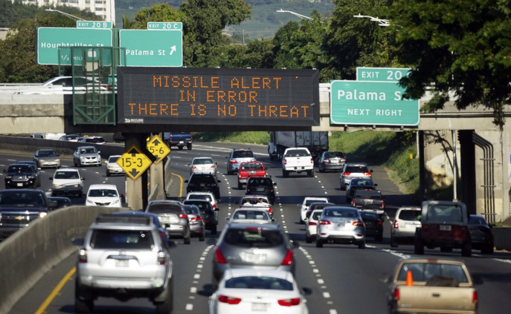 Cars drive past a highway sign that says "MISSILE ALERT ERROR THERE IS NO THREAT" on the H-1 Freeway in Honolulu, Hawaii, on Jan. 13. A Hawaii employee mistakenly sent an alert warning of an incoming ballistic missile.